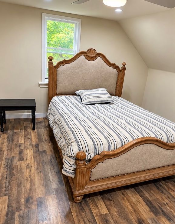 Bedroom with an upholstered carved bed frame