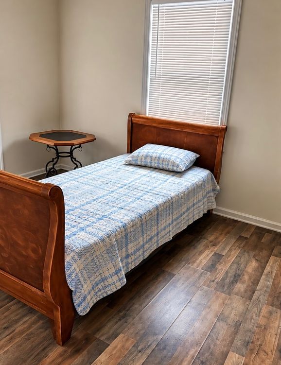 Bedroom with a twin sleigh bed and side table