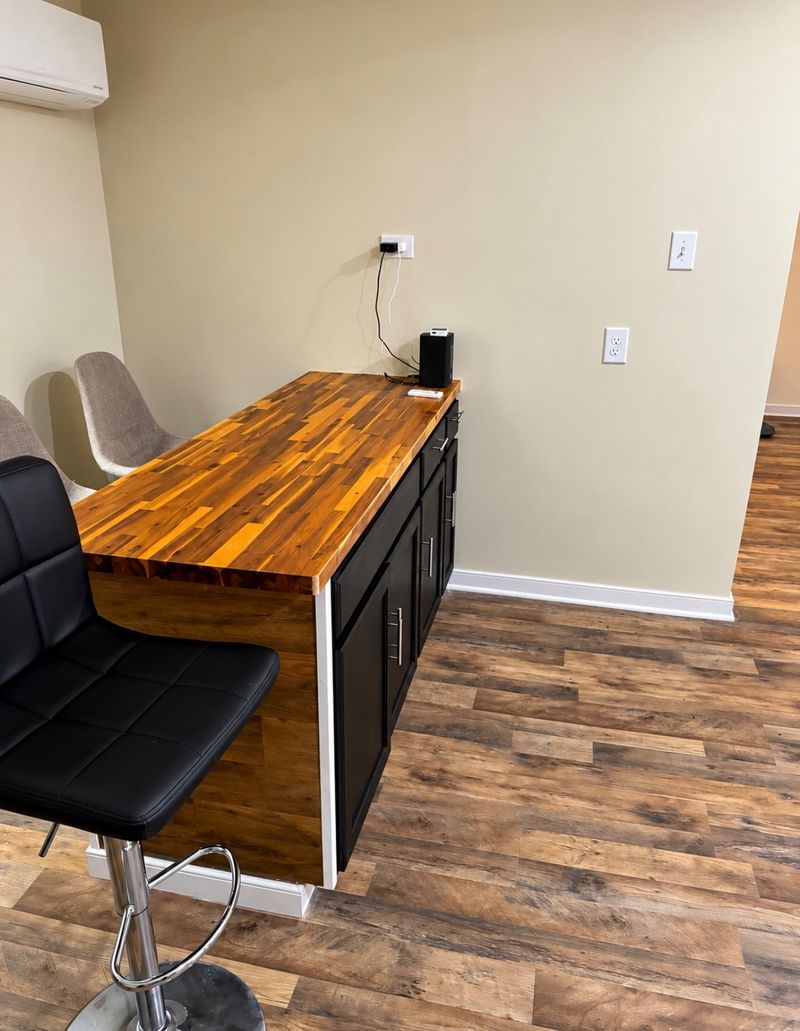 Wood-topped breakfast bar with stools